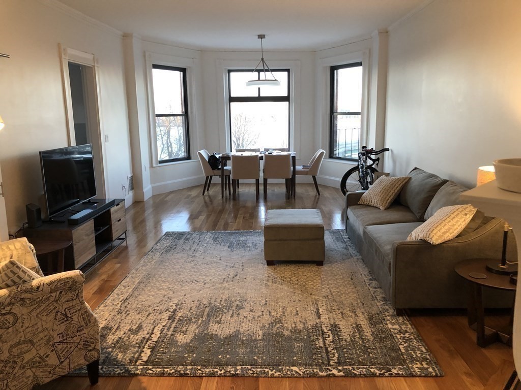 29 Bay State Road, Unit 3 Boston, MA 02215 - Photo 4 of 22 a living room with furniture a window and a flat screen tv
