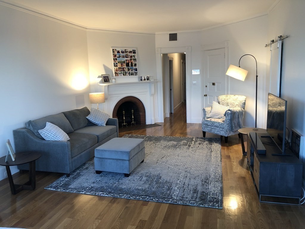 29 Bay State Road, Unit 3 Boston, MA 02215 - Photo 6 of 22 a living room with furniture and a fireplace