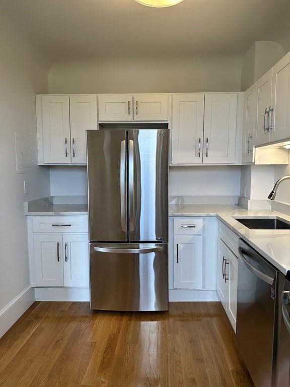 29 Bay State Road, Unit 3 Boston, MA 02215 - Photo 9 of 22 a kitchen with wooden floors and appliances