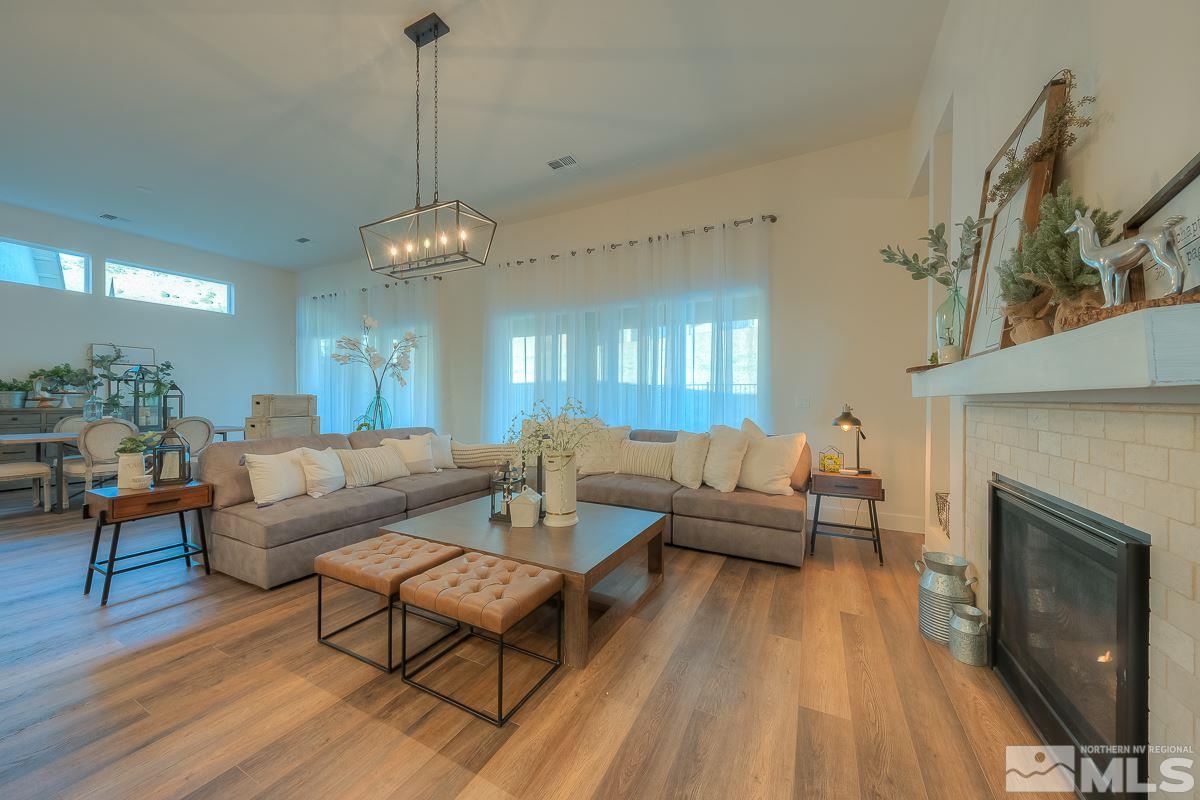 3018 Copper Stone Drive Reno, NV 89521 - Photo 16 of 29 a living room with furniture a fireplace and a chandelier