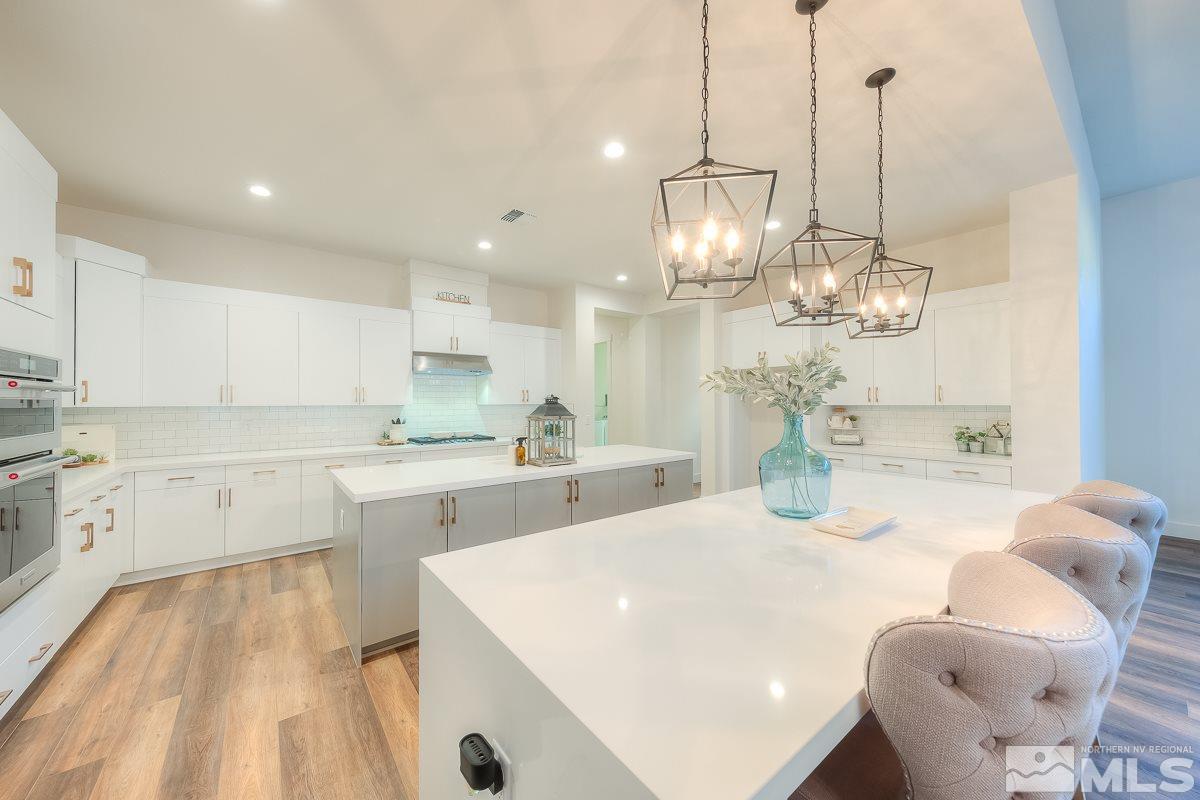 3018 Copper Stone Drive Reno, NV 89521 - Photo 20 of 29 a kitchen with granite countertop a white cabinets and chairs