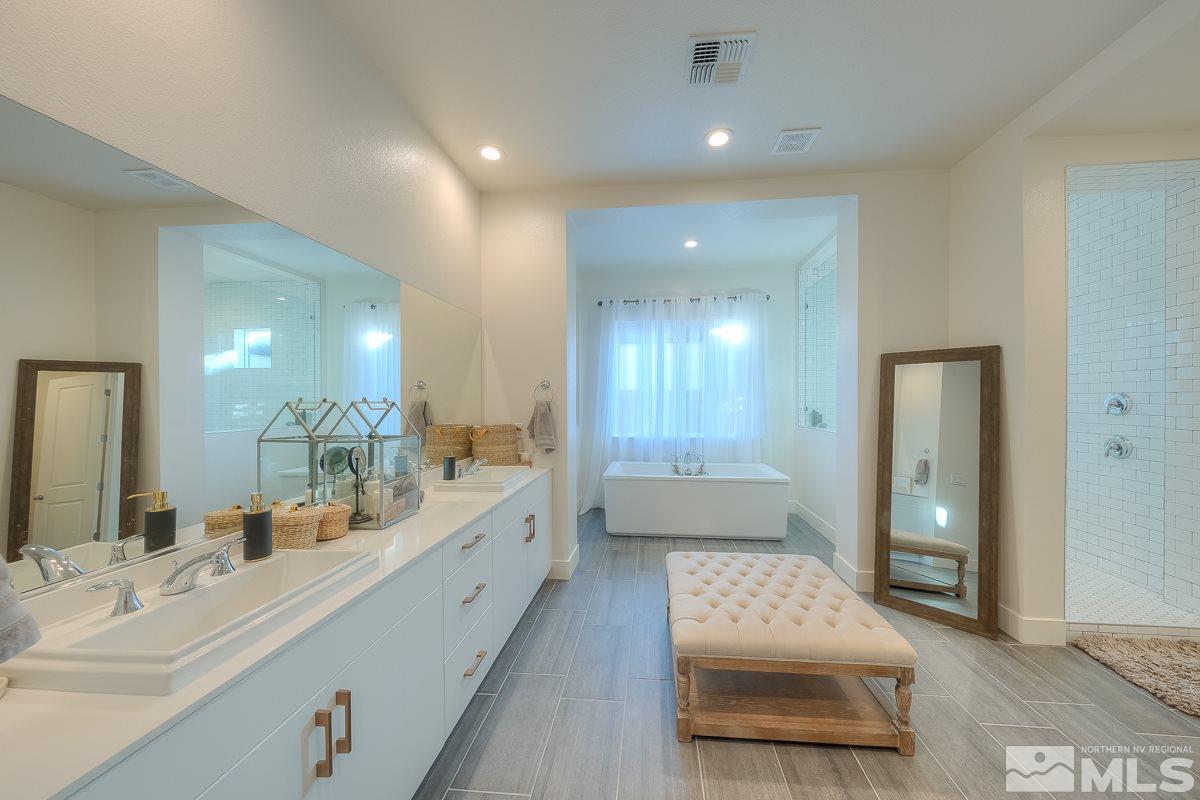 3018 Copper Stone Drive Reno, NV 89521 - Photo 2 of 29 a bathroom with a sink mirror and a bath tub