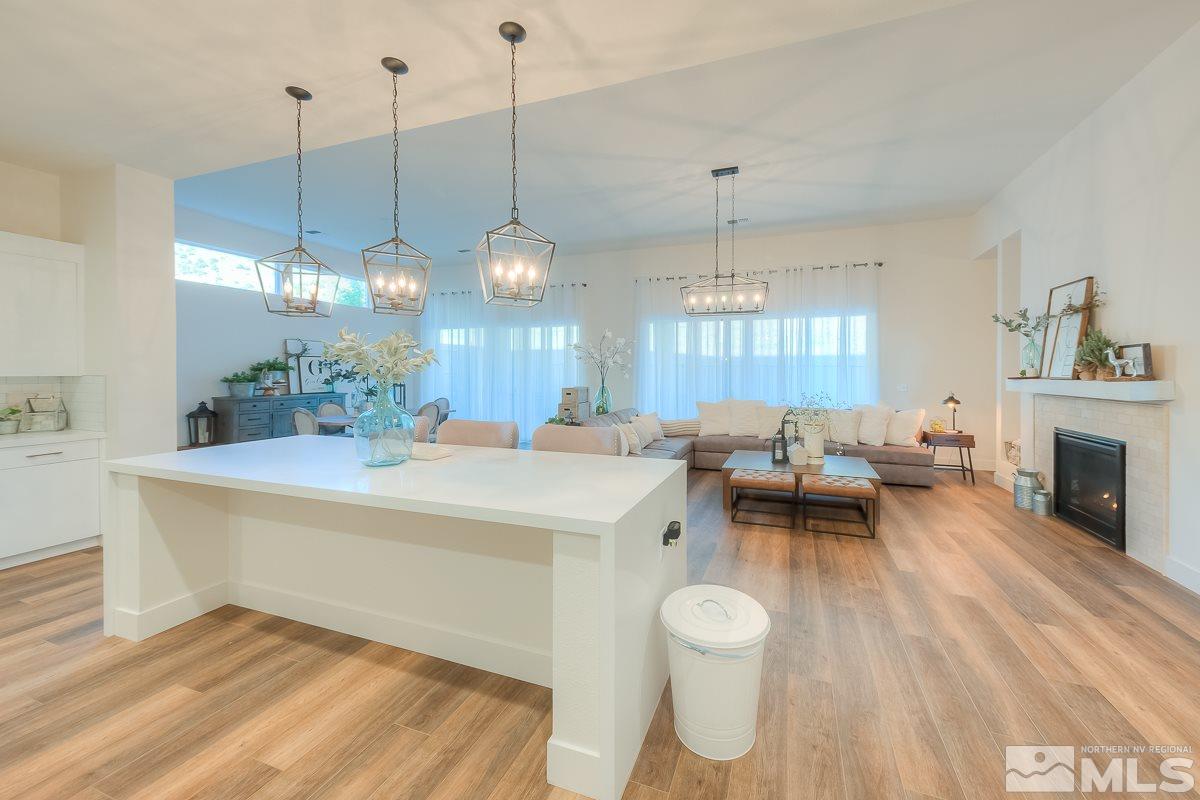 3018 Copper Stone Drive Reno, NV 89521 - Photo 21 of 29 a living room with furniture a fireplace and a chandelier