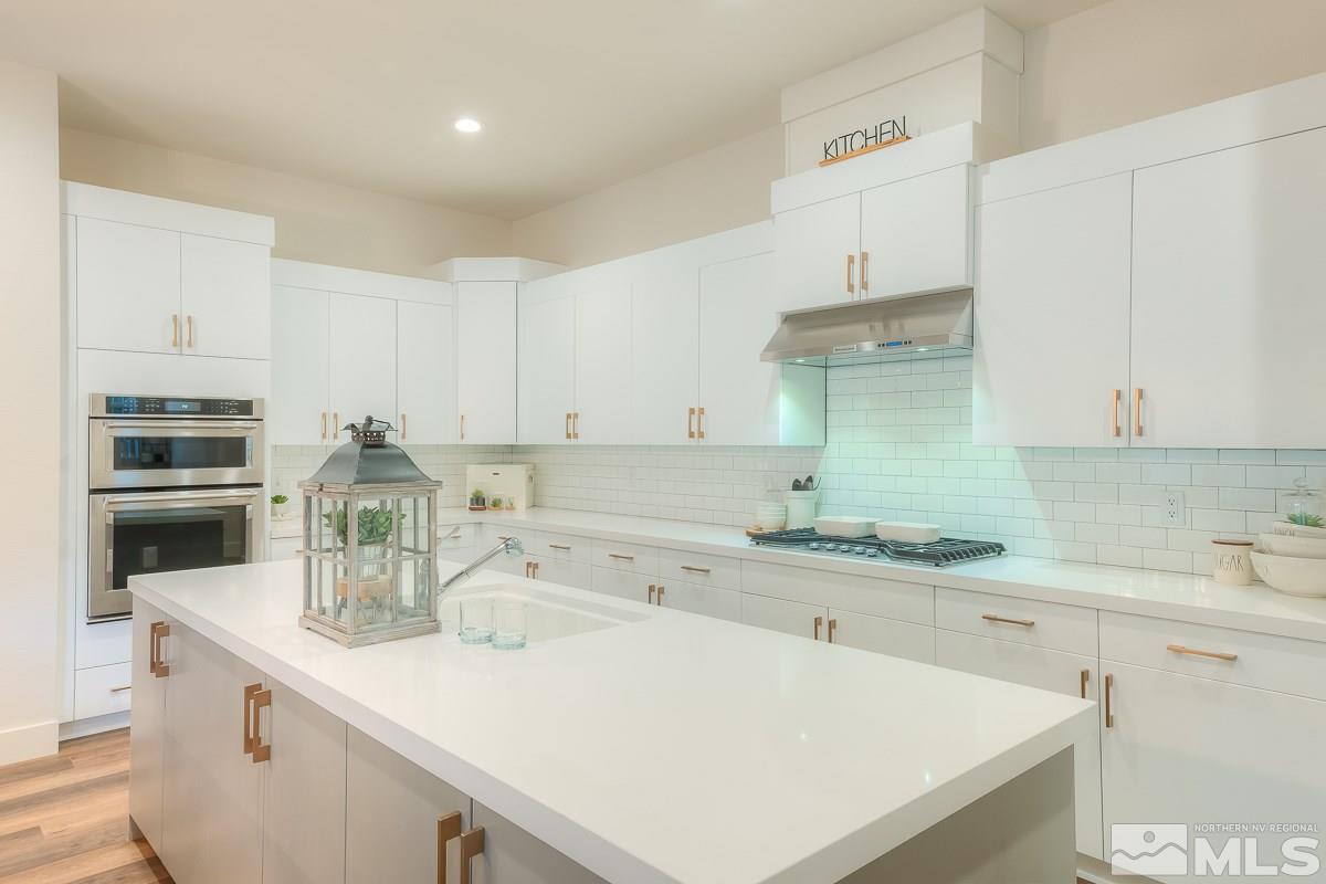 3018 Copper Stone Drive Reno, NV 89521 - Photo 23 of 29 a kitchen with a sink a stove and cabinets