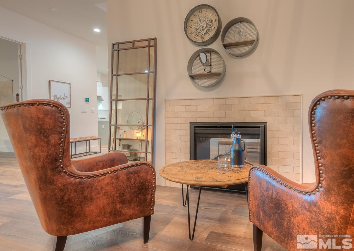 3018 Copper Stone Drive Reno, NV 89521 - Photo 27 of 29 a living room with furniture a window and a fireplace