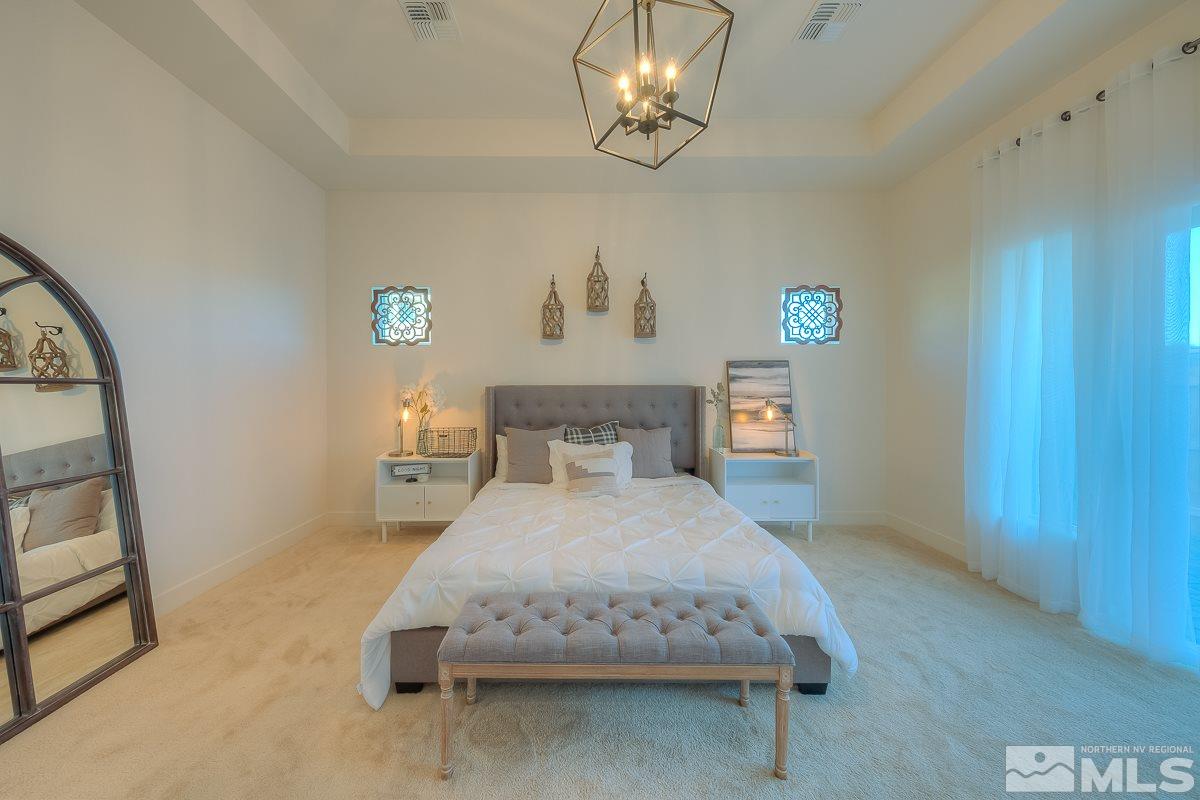 3018 Copper Stone Drive Reno, NV 89521 - Photo 6 of 29 a bedroom with a bed and a table in it