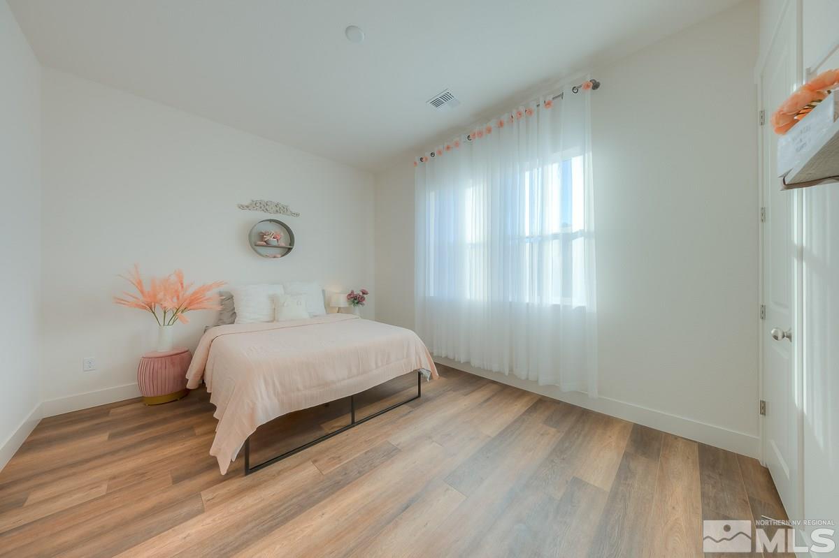 3018 Copper Stone Drive Reno, NV 89521 - Photo 10 of 29 a bedroom with a bed and a window