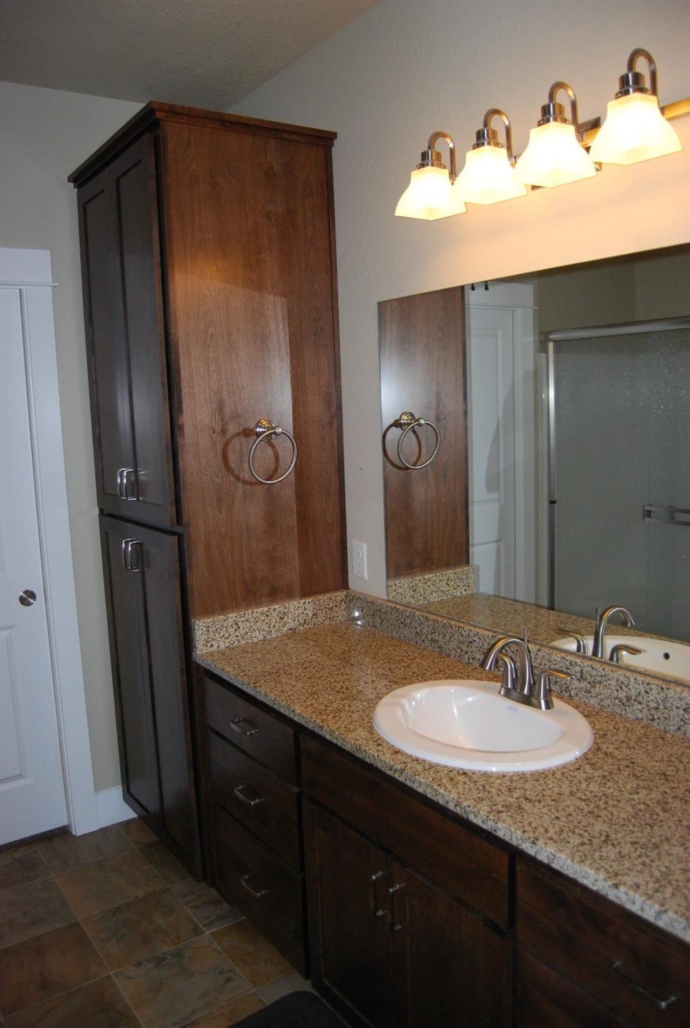 1171 North Haskell Street Central Point, OR 97502 - Photo 13 of 19 a bathroom with a granite countertop sink shower and a mirror