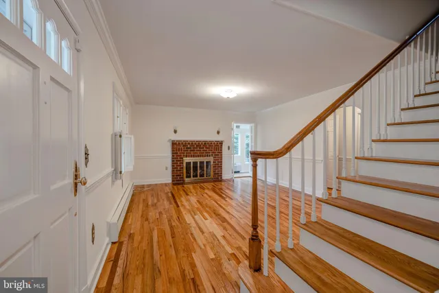 a view of entryway and hall with wooden floor