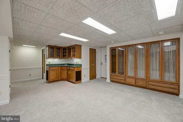 a spacious bathroom with a granite countertop sink and washing machine
