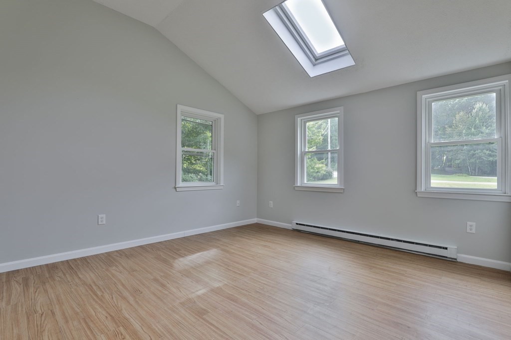 12 Al Derry Nh 03038, Unit R Derry, NH 03038 - Photo 12 of 23 a view of an empty room with wooden floor and a window