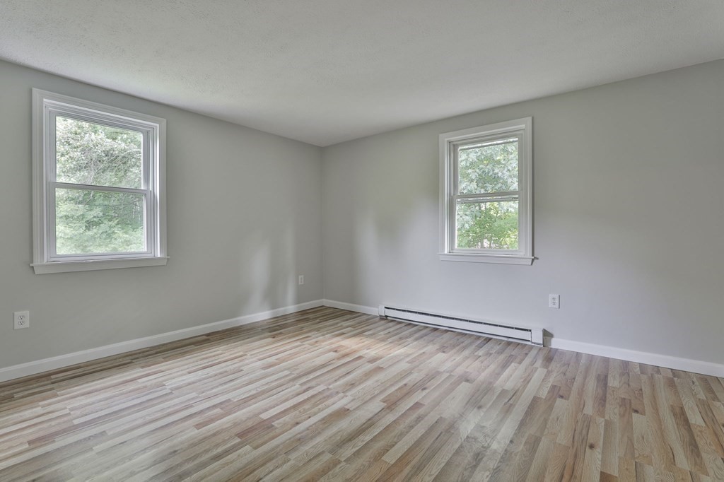 12 Al Derry Nh 03038, Unit R Derry, NH 03038 - Photo 16 of 23 a view of an empty room with wooden floor and a window