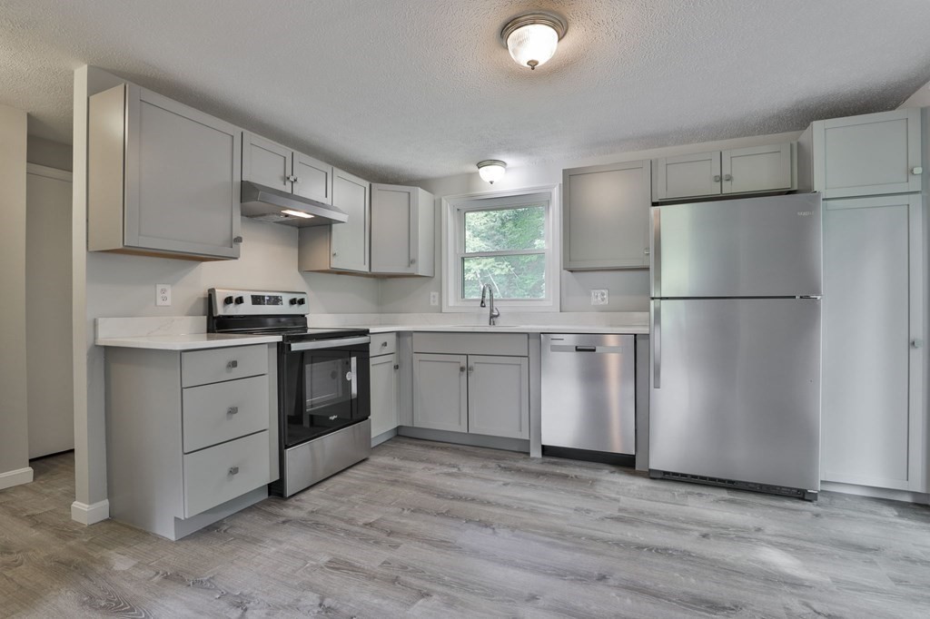 12 Al Derry Nh 03038, Unit R Derry, NH 03038 - Photo 2 of 23 a kitchen with white cabinets and white appliances