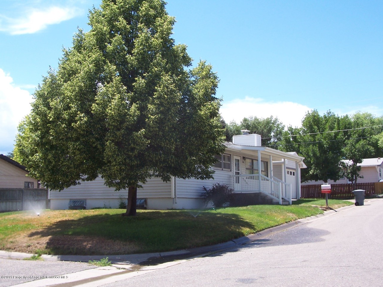 703 West 3rd Street Rifle, CO 81650 - Photo 18 of 22 a view of a house with a yard and large trees