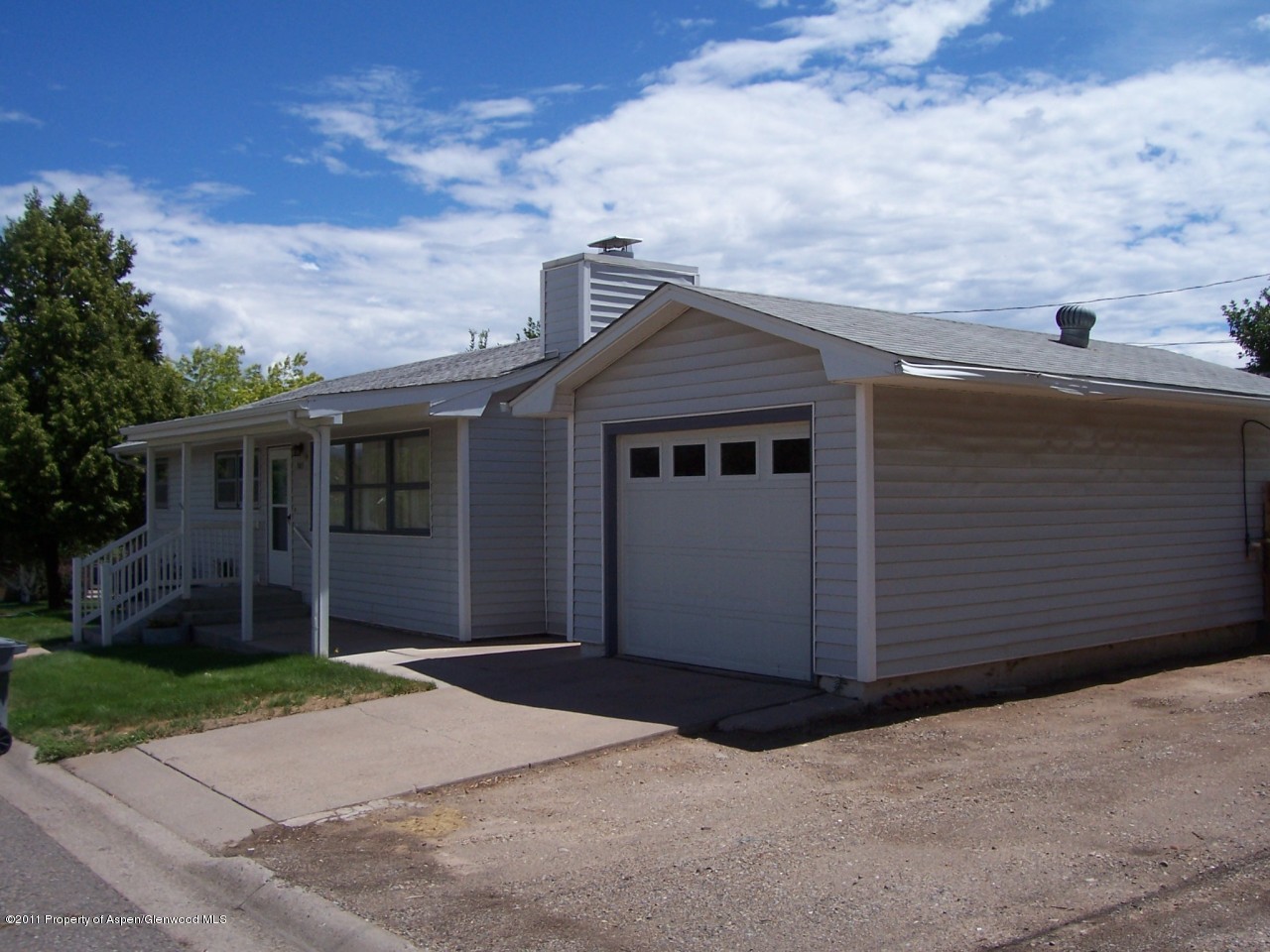 703 West 3rd Street Rifle, CO 81650 - Photo 2 of 22 a front view of a house with a garden