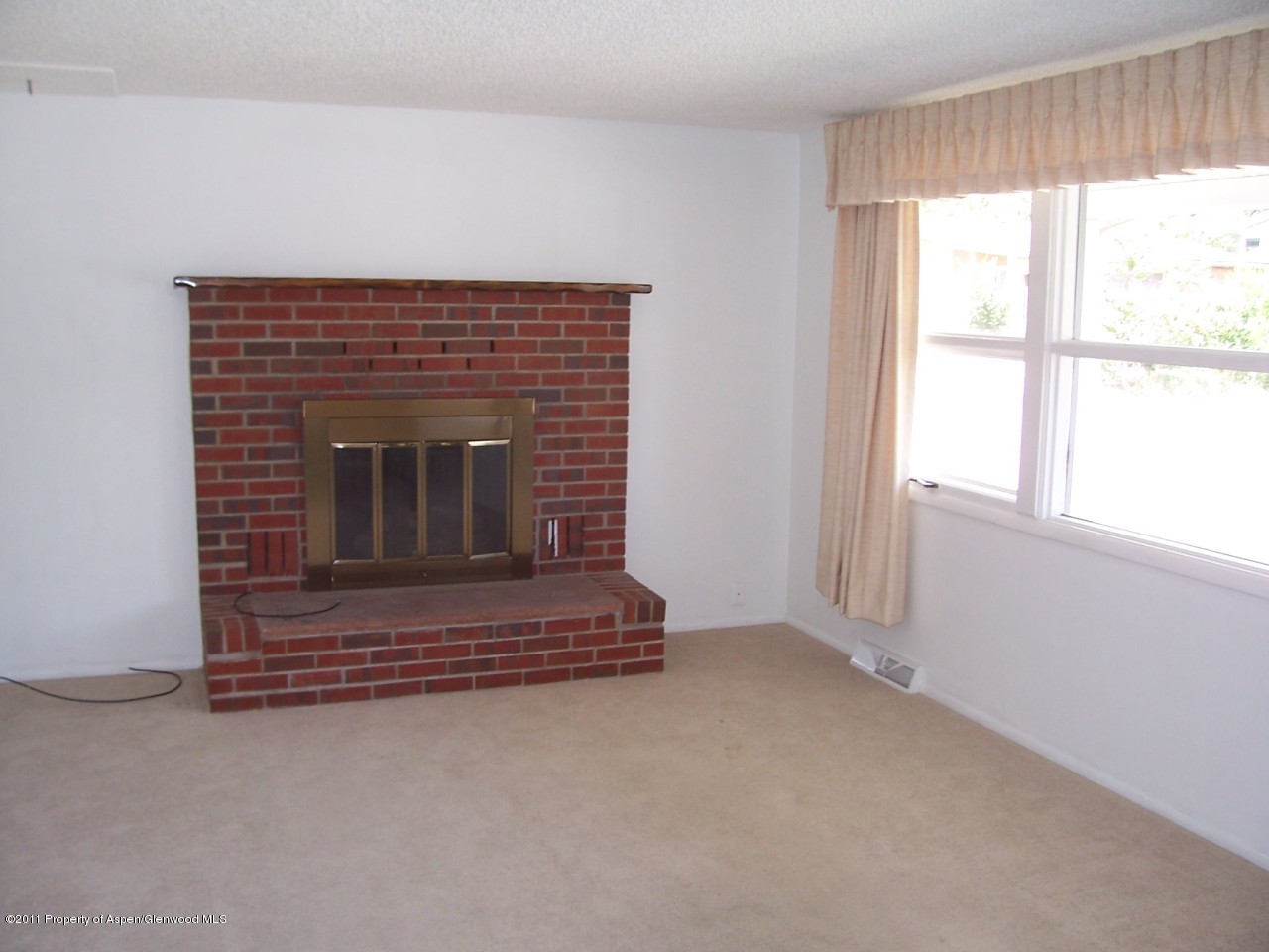 703 West 3rd Street Rifle, CO 81650 - Photo 4 of 22 a living room with a fireplace