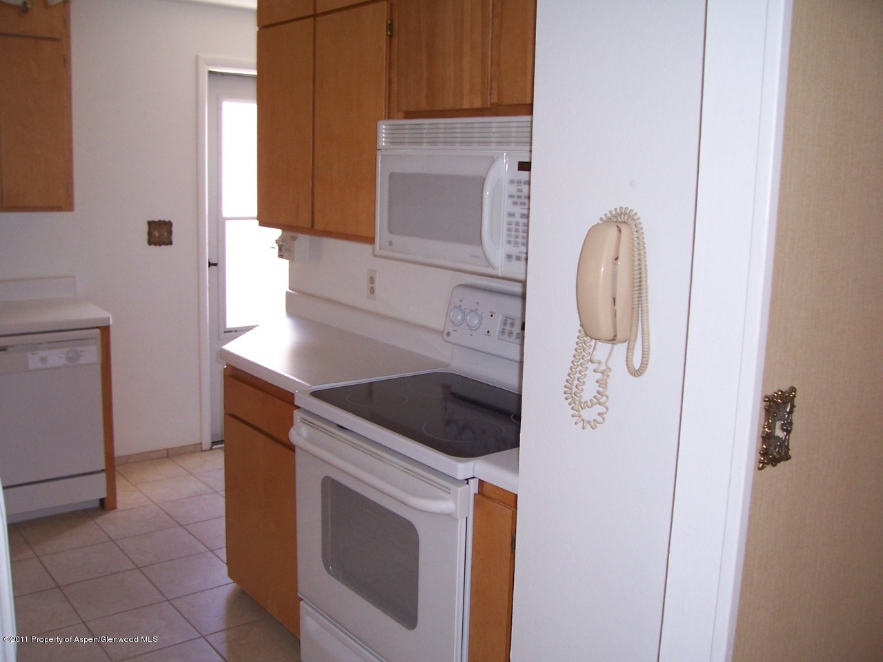 703 West 3rd Street Rifle, CO 81650 - Photo 8 of 22 a kitchen with a sink and a washer dryer