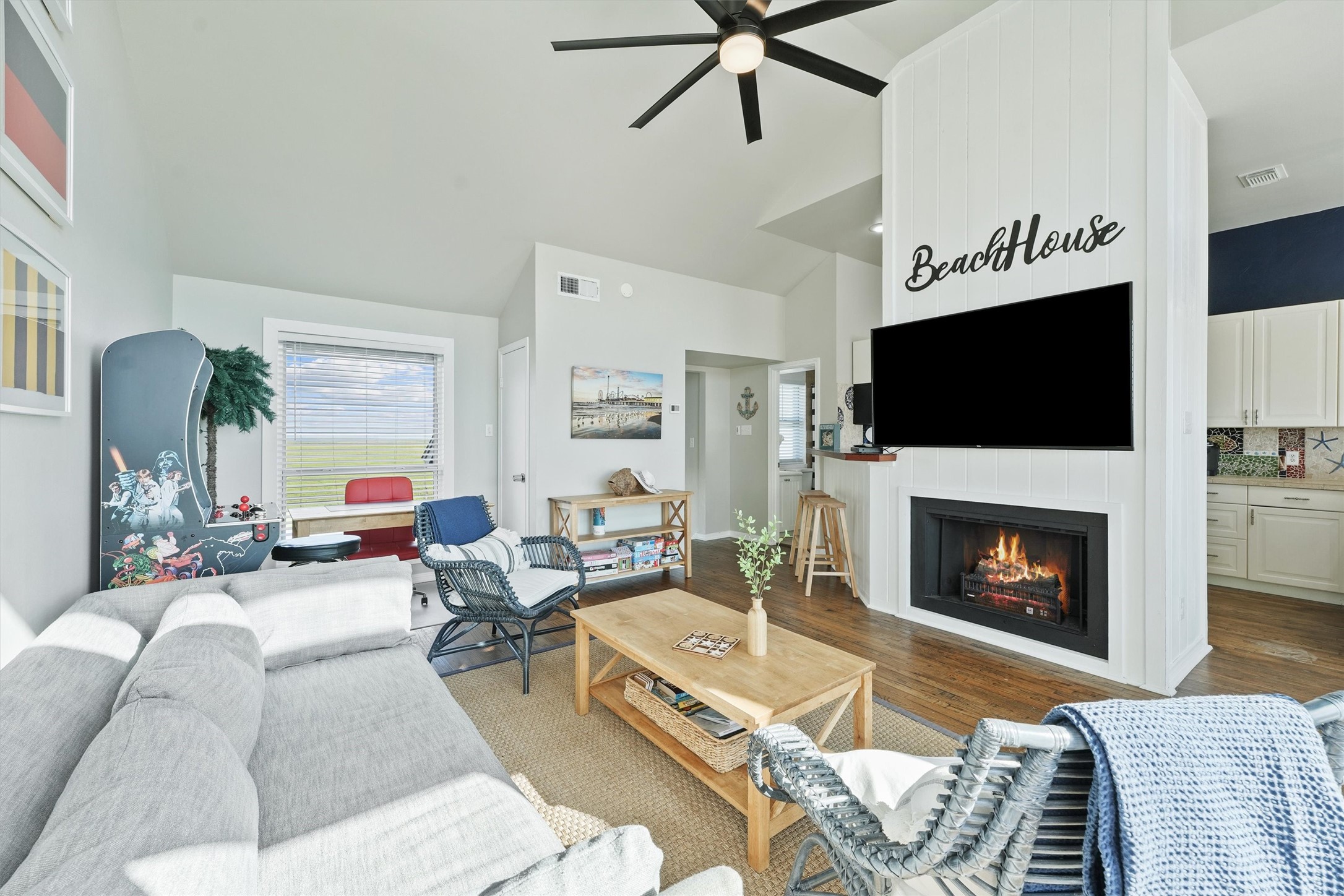17607 Termini-San Luis Pass Road Galveston, TX 77554 - Photo 9 of 42 With a modern ceiling fan and ample seating space, this living room is ideal for comfort and casual entertaining. The décor and thoughtful design elements, like the built-in fireplace, add charm and make this coastal retreat feel like home.