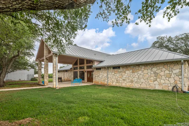 a view of a patio with a table and chairs next to a yard