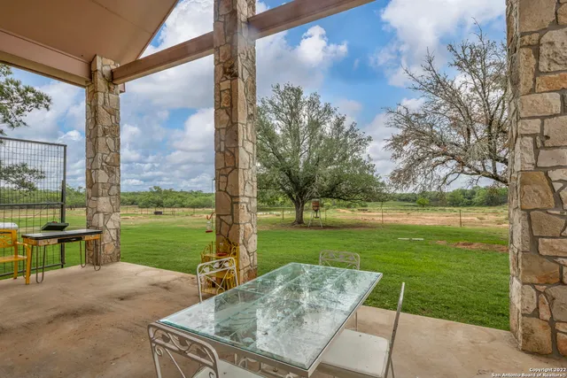 a room with pool table and windows
