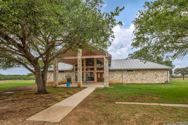 a building outdoor space with patio furniture and potted plants