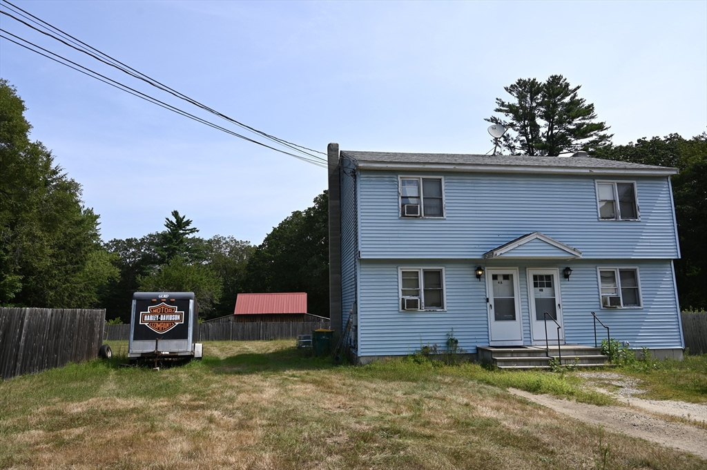 4 Spring Street Rochester, NH 03868 - Photo 13 of 29 a front view of a house with a garden and yard