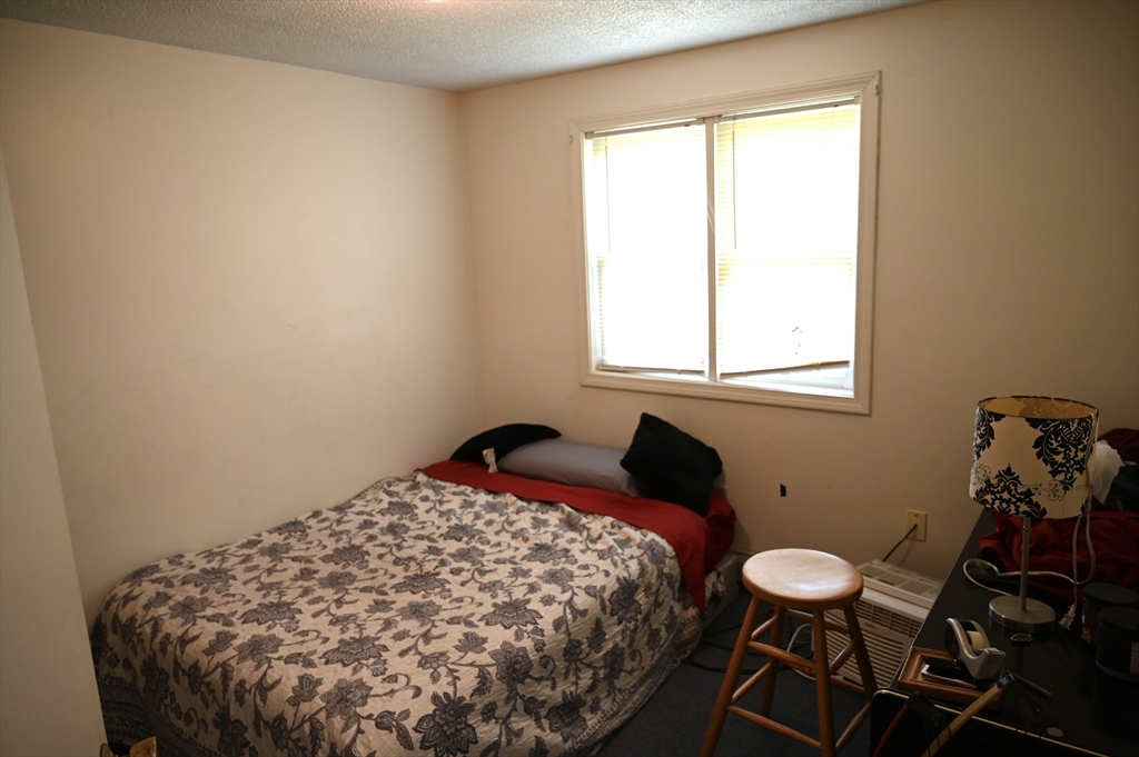 4 Spring Street Rochester, NH 03868 - Photo 16 of 29 a bed sitting in a bedroom next to a window