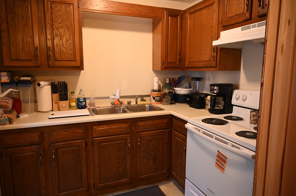 4 Spring Street Rochester, NH 03868 - Photo 19 of 29 a kitchen with stainless steel appliances granite countertop a sink stove and microwave