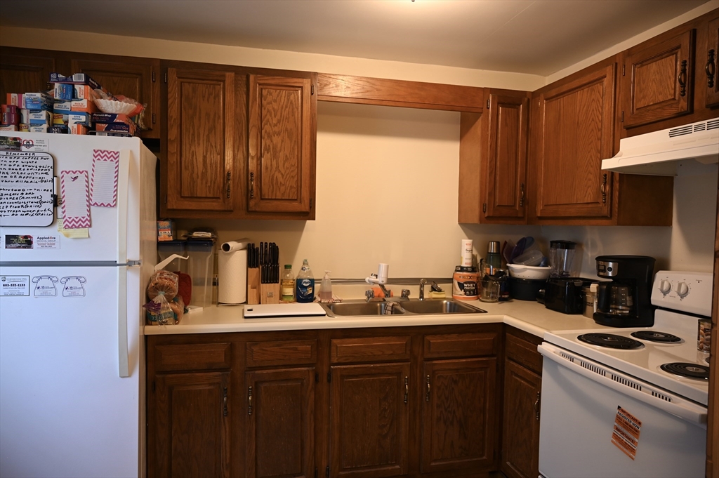 4 Spring Street Rochester, NH 03868 - Photo 21 of 29 a kitchen with a sink a stove and cabinets