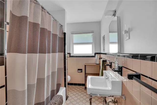 a view of a house with a yard and potted plants