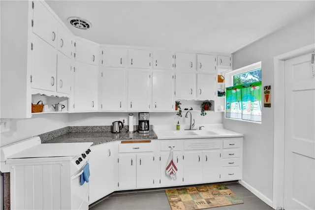 a kitchen with refrigerator and cabinets