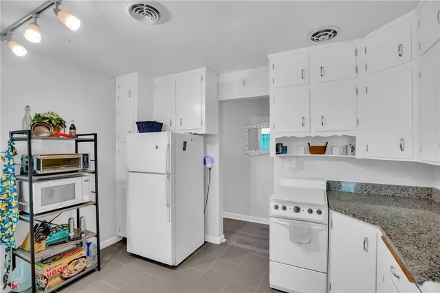 a kitchen that has a cabinets and window