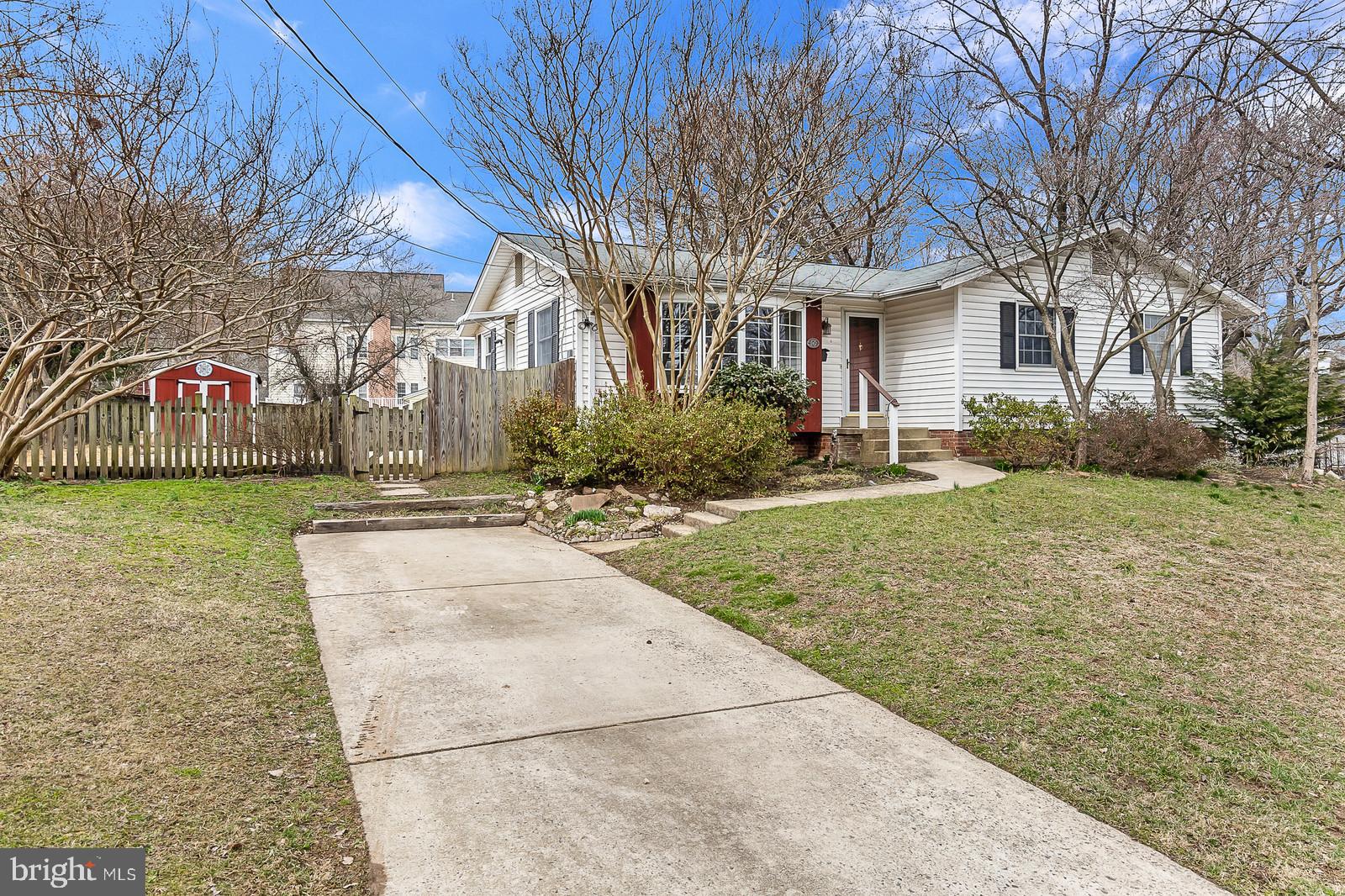 a view of a street with a building and trees