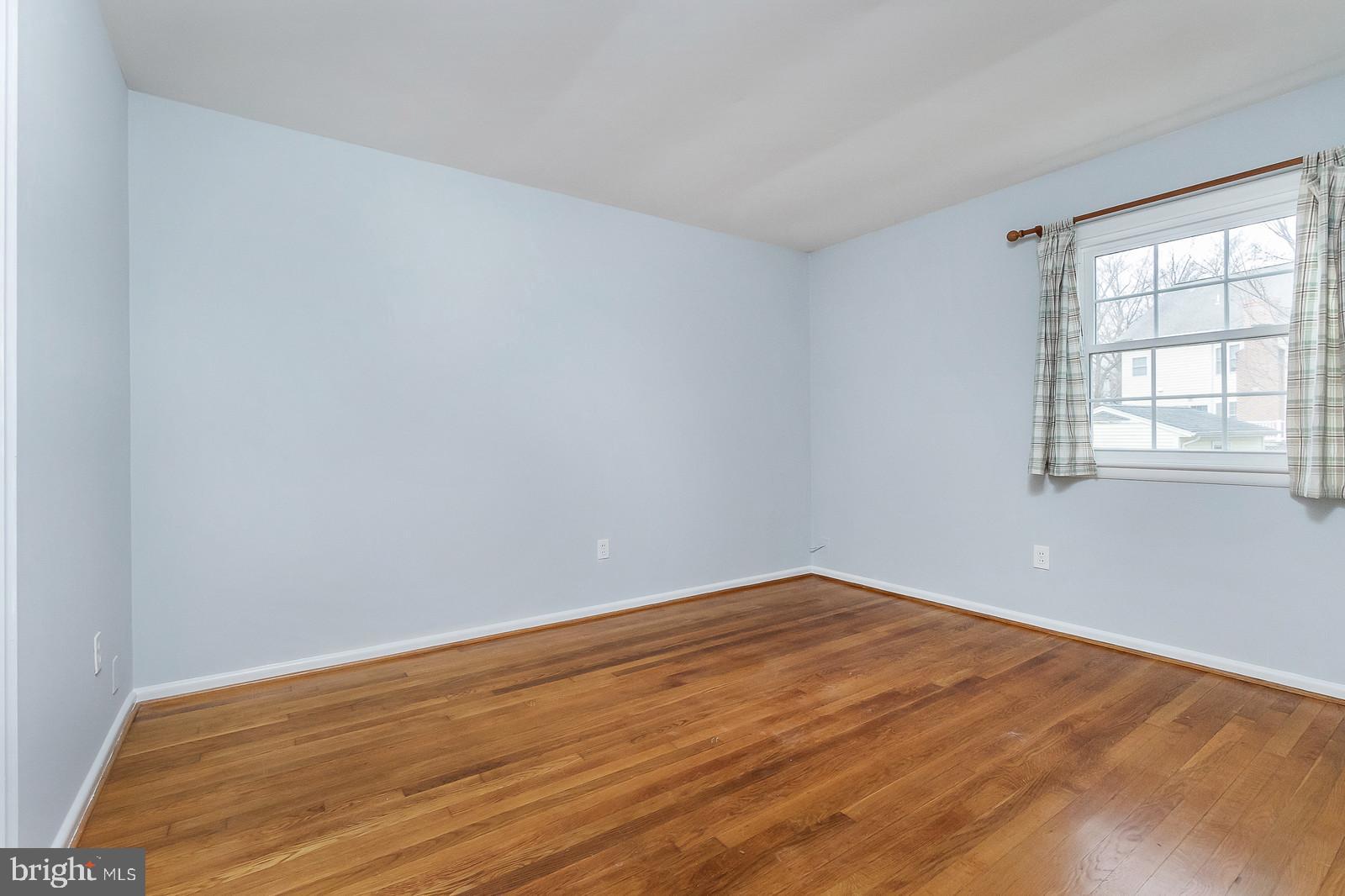 409 Orleans Circle Southwest Vienna, VA 22180 - Photo 14 of 23 wooden floor in an empty room with a window