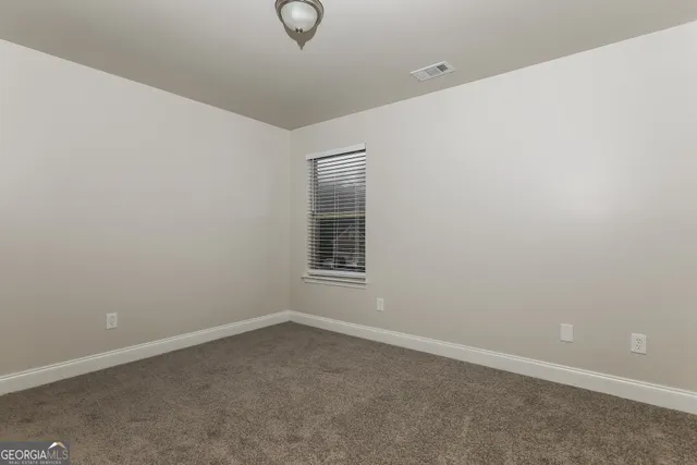 an empty room with a empty space and windows