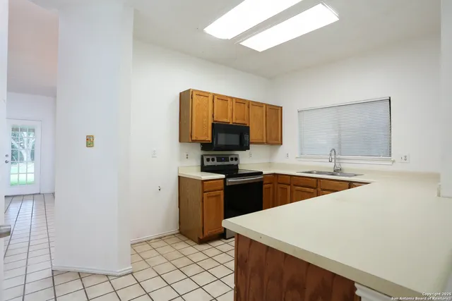 a kitchen with stainless steel appliances granite countertop a sink and a stove