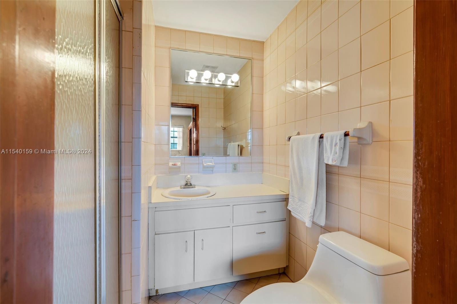 Westchester Miami, FL 33165 - Photo 11 of 30 a bathroom with a toilet sink shower and mirror