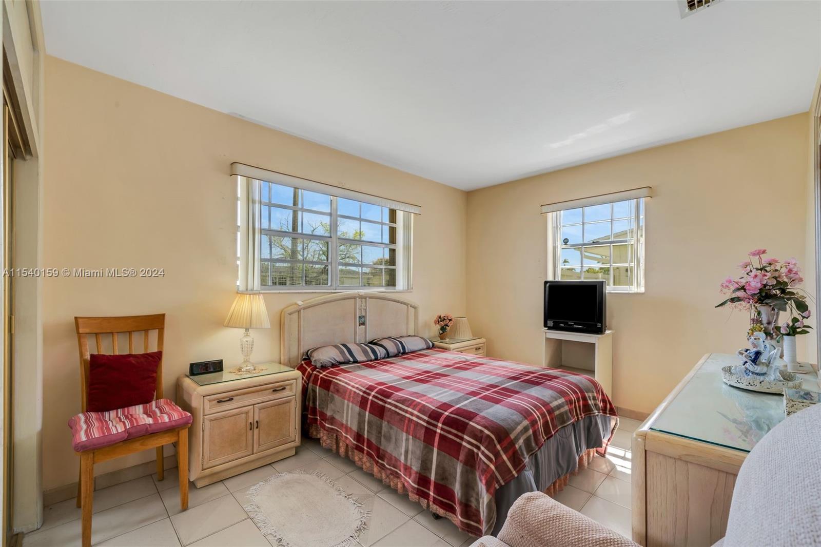 Westchester Miami, FL 33165 - Photo 13 of 30 a spacious bedroom with a bed and wooden floor