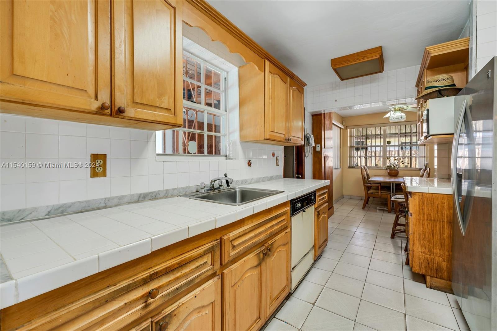 Westchester Miami, FL 33165 - Photo 18 of 30 a kitchen with stainless steel appliances granite countertop a sink and cabinets
