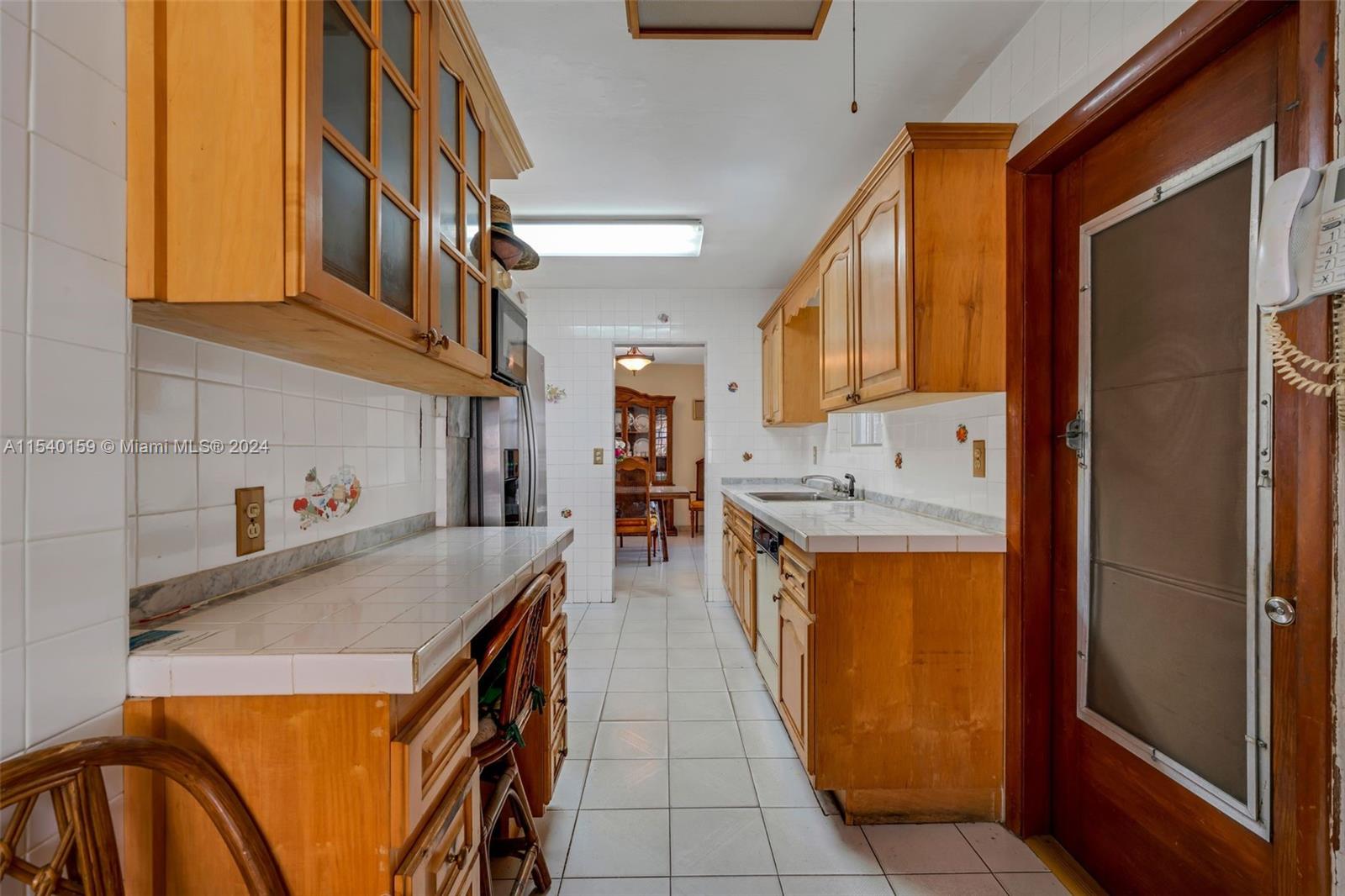 Westchester Miami, FL 33165 - Photo 21 of 30 a kitchen with stainless steel appliances granite countertop a sink and cabinets