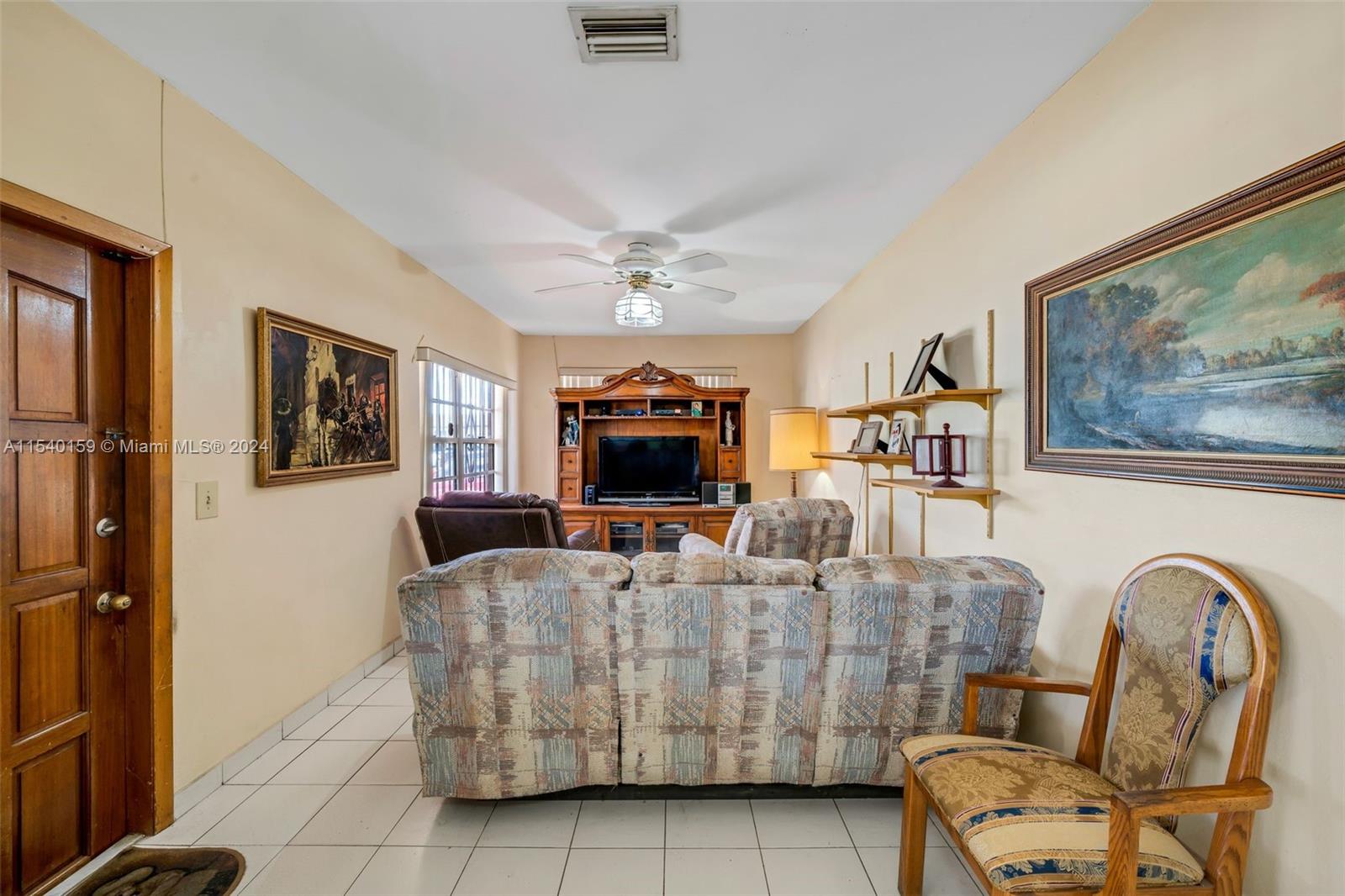 Westchester Miami, FL 33165 - Photo 22 of 30 a living room with furniture and a flat screen tv