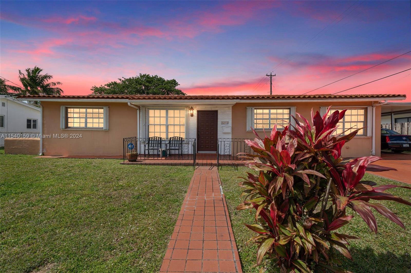 Westchester Miami, FL 33165 - Photo 4 of 30 a front view of a house with a garden and yard