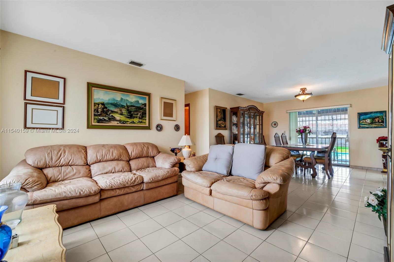 Westchester Miami, FL 33165 - Photo 5 of 30 a living room with furniture a couch and paintings on the wall