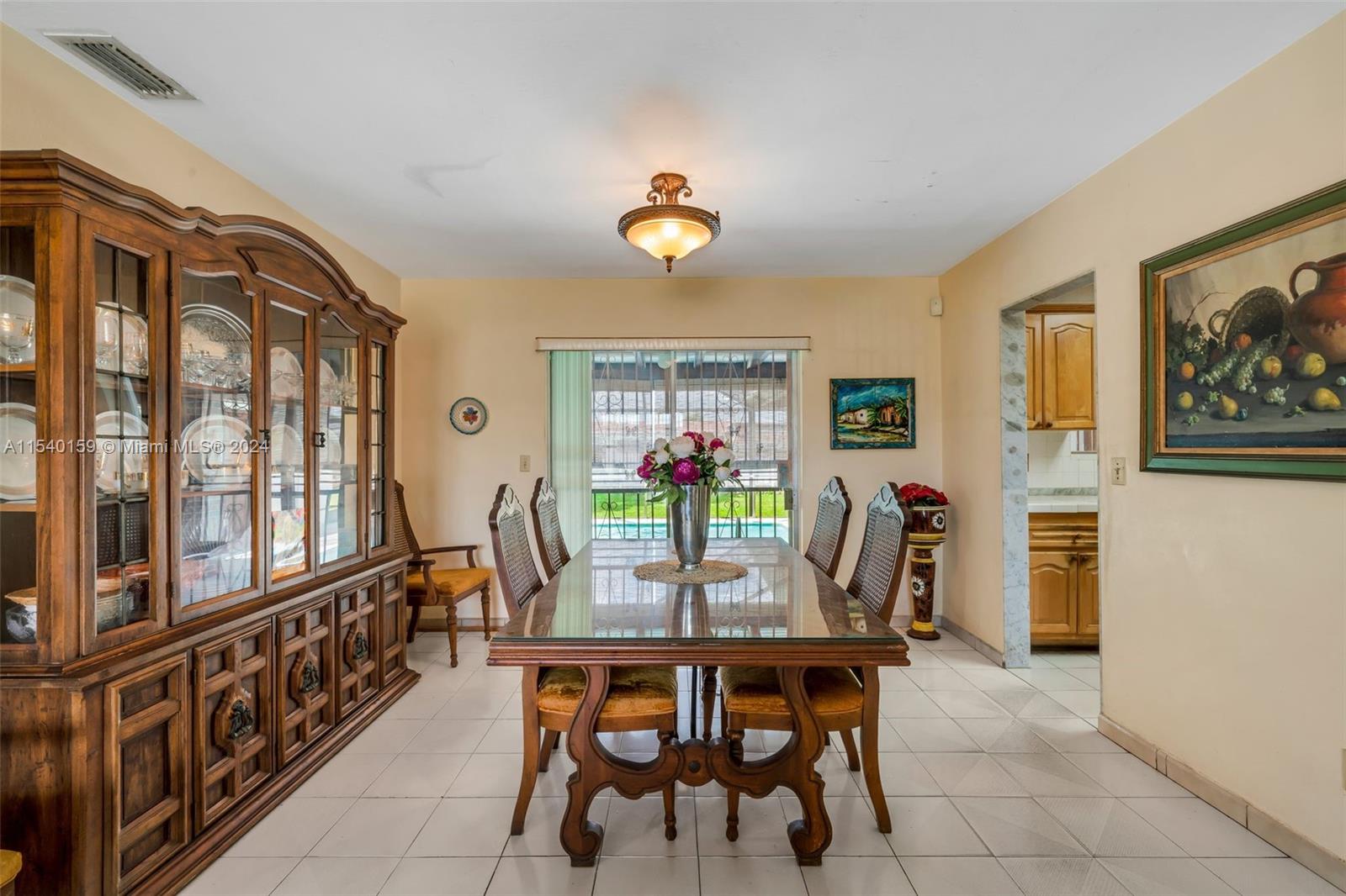 Westchester Miami, FL 33165 - Photo 7 of 30 a dining room with furniture a window and a chandelier