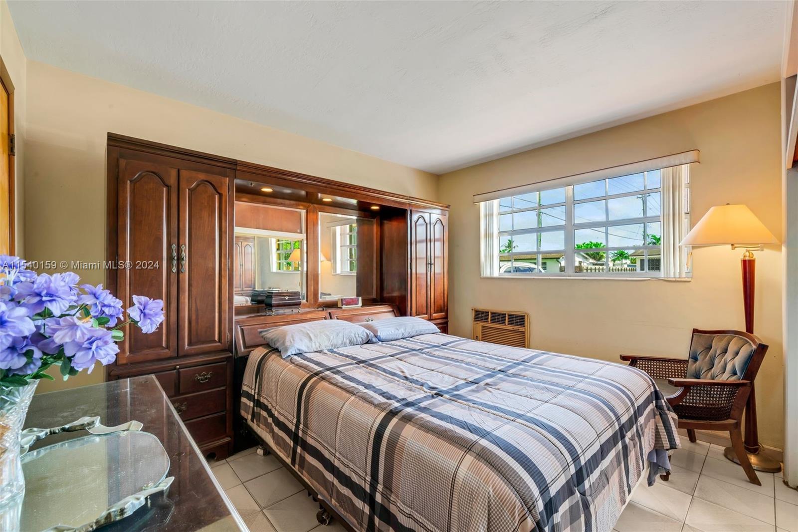 Westchester Miami, FL 33165 - Photo 9 of 30 a bedroom with a bed potted plant and a window
