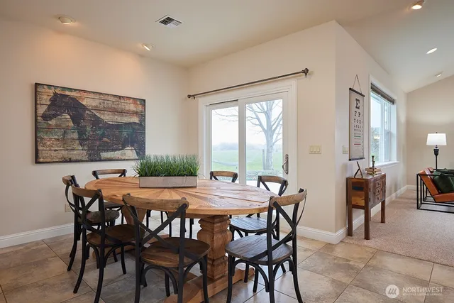 a dining room with furniture and window