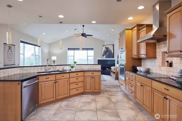 a large kitchen with stainless steel appliances lots of counter space and a sink