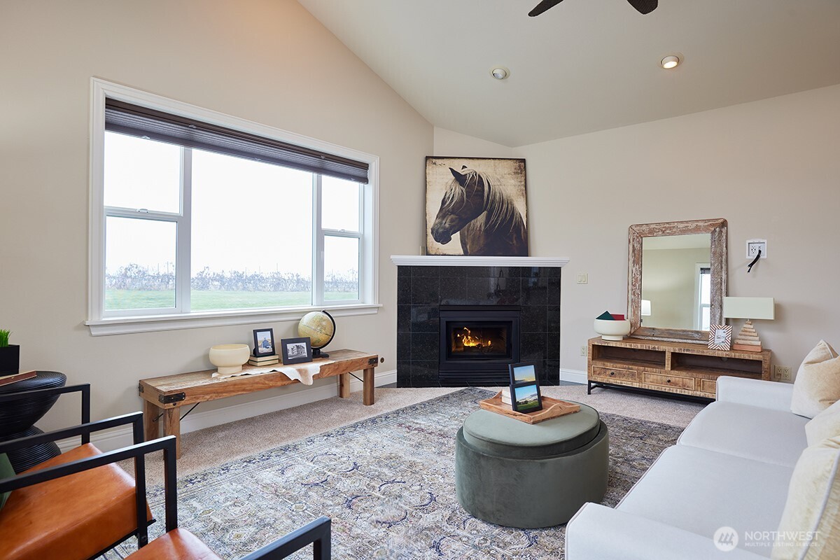 198 Narcissa Place Walla Walla, WA 99362 - Photo 15 of 40 a living room with furniture a fireplace and a floor to ceiling window