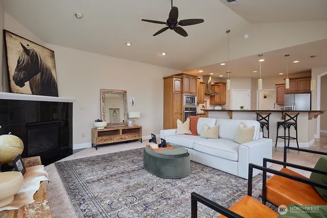 a living room with furniture and kitchen view