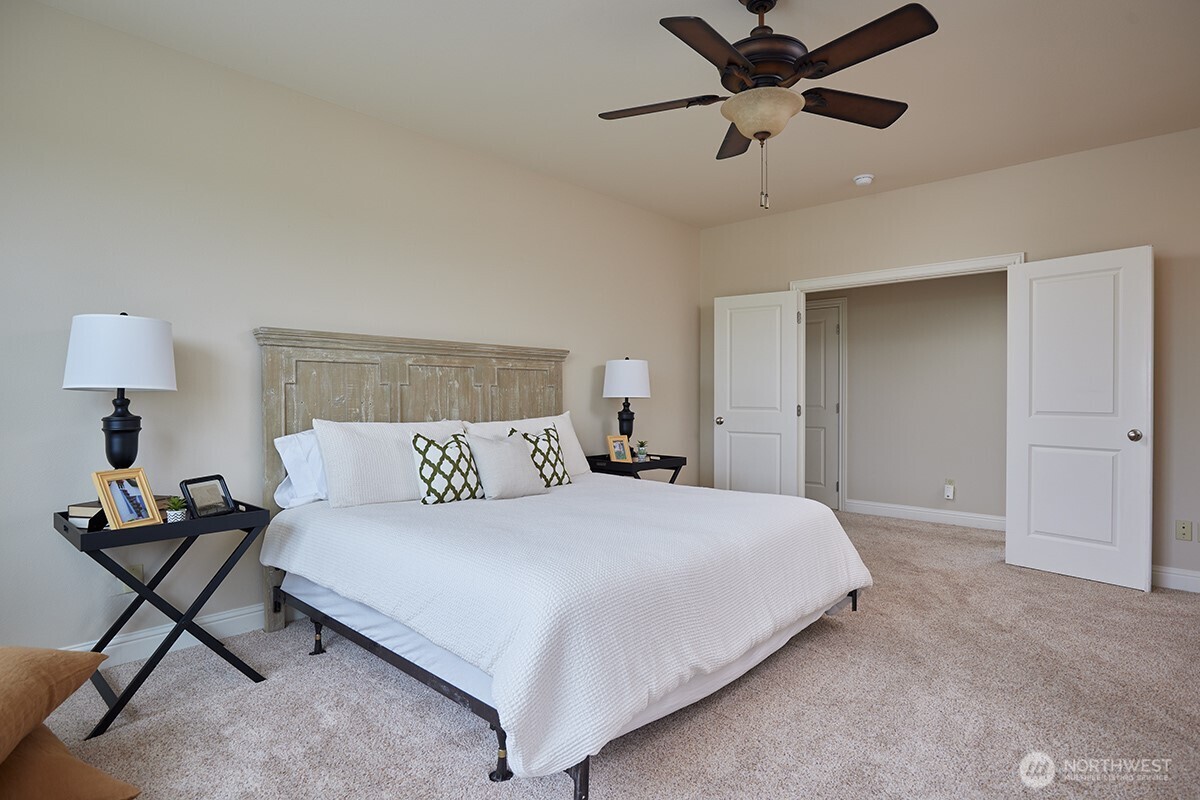 198 Narcissa Place Walla Walla, WA 99362 - Photo 21 of 40 a bedroom with a bed and a chandelier